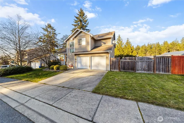 a front view of a house with a yard and garage