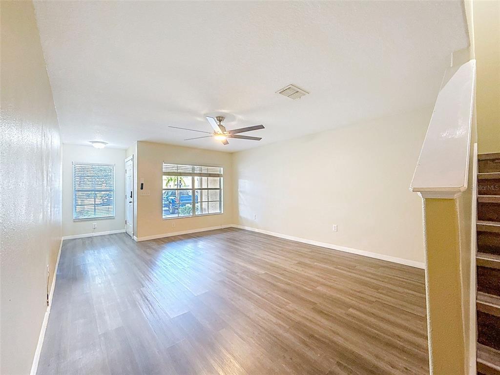 9873 Trumpet Vine Loop Trinity, FL 34655 - Photo 14 of 40 wooden floor in an empty room with a window