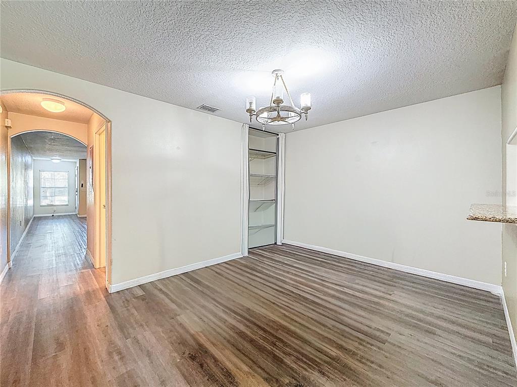 9873 Trumpet Vine Loop Trinity, FL 34655 - Photo 16 of 40 wooden floor in an empty room with a window