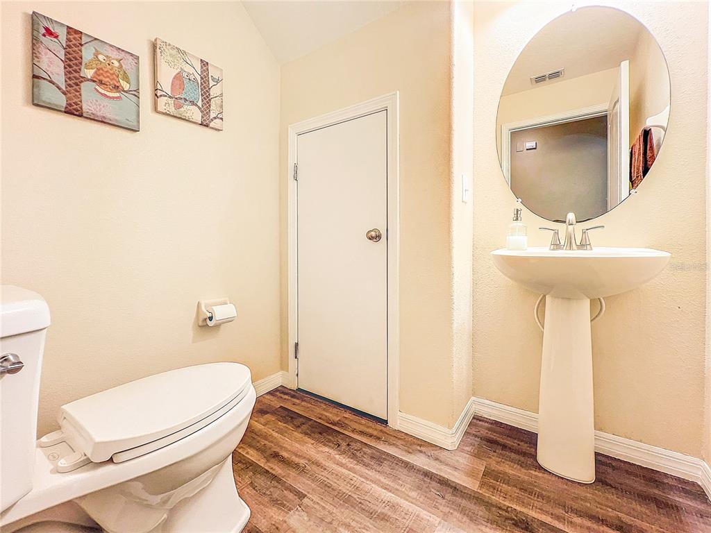 9873 Trumpet Vine Loop Trinity, FL 34655 - Photo 17 of 40 a bathroom with a toilet a sink and mirror