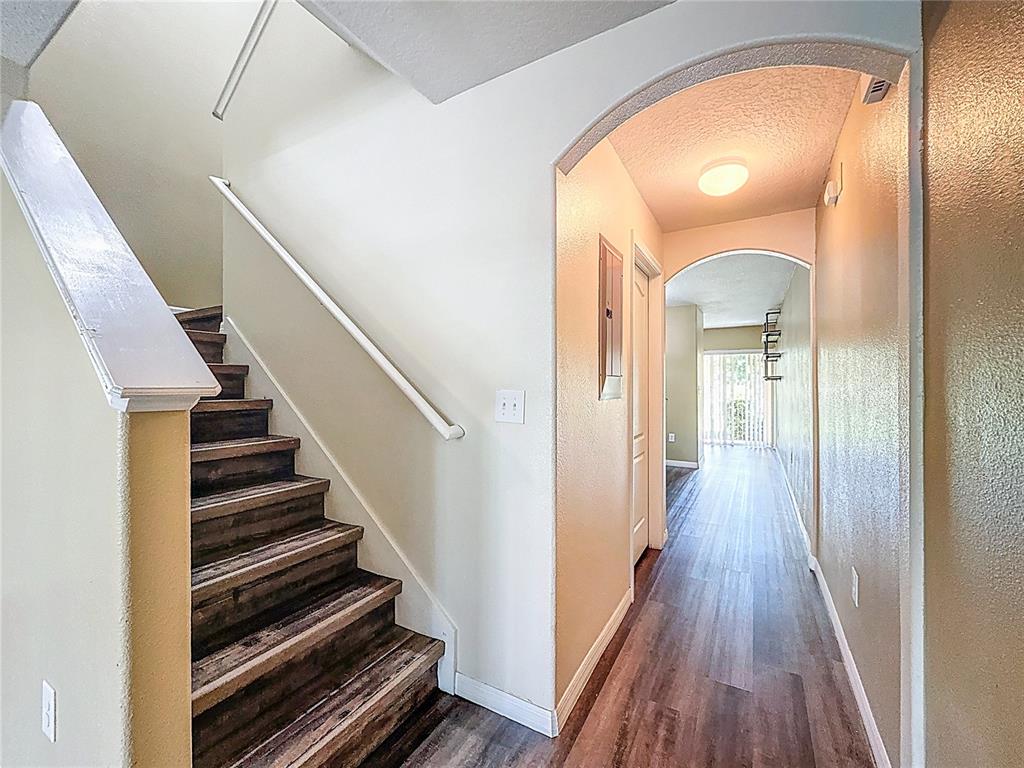 9873 Trumpet Vine Loop Trinity, FL 34655 - Photo 18 of 40 a view of a hallway with wooden floor and staircase