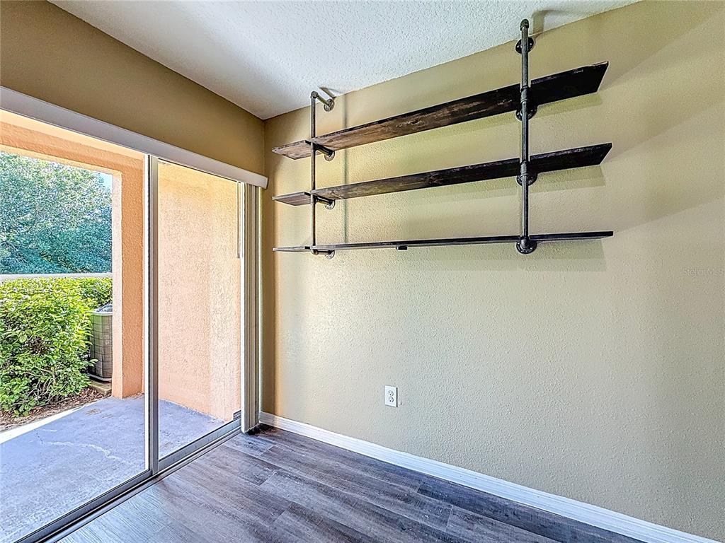9873 Trumpet Vine Loop Trinity, FL 34655 - Photo 21 of 40 a view of an empty room with wooden floor and a window