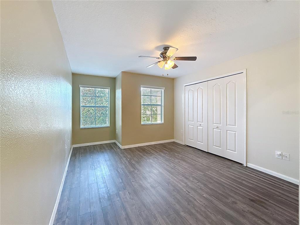 9873 Trumpet Vine Loop Trinity, FL 34655 - Photo 23 of 40 a view of an empty room with a window and wooden floor