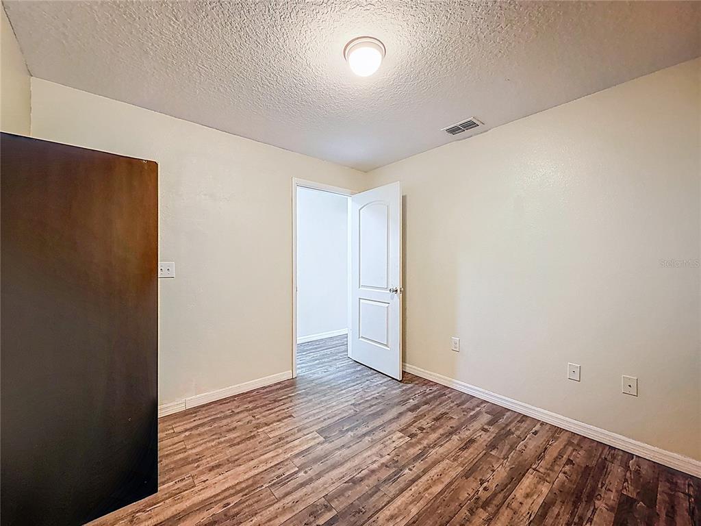 9873 Trumpet Vine Loop Trinity, FL 34655 - Photo 31 of 40 a view of an empty room with wooden floor