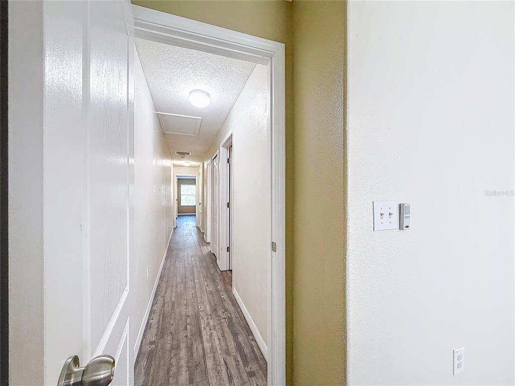9873 Trumpet Vine Loop Trinity, FL 34655 - Photo 32 of 40 a view of a hallway with wooden floor