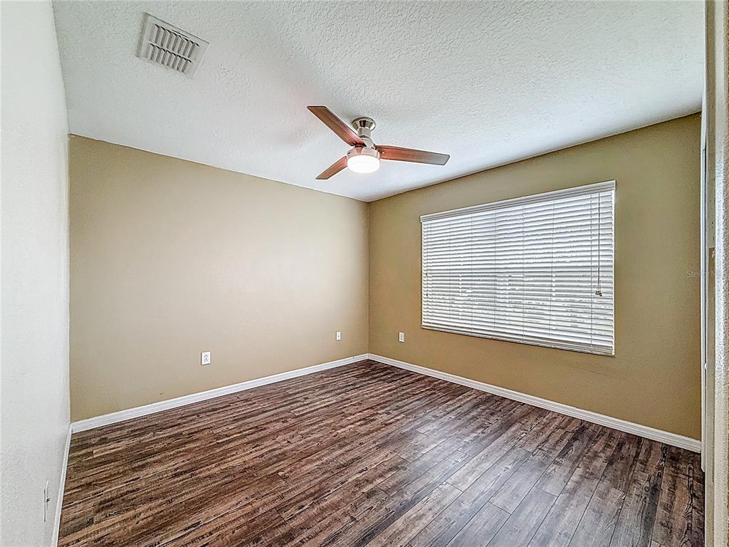 9873 Trumpet Vine Loop Trinity, FL 34655 - Photo 37 of 40 a view of a room with wooden floor and a window