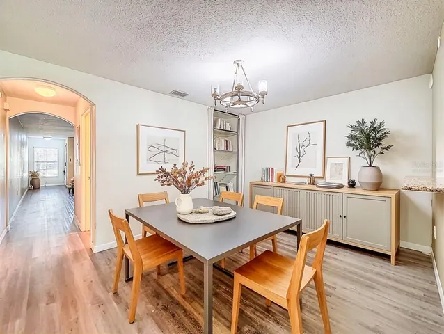 a living room with furniture flat screen tv and window