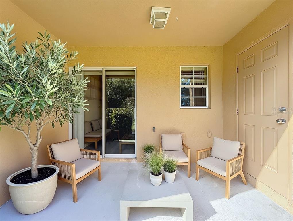 9873 Trumpet Vine Loop Trinity, FL 34655 - Photo 10 of 40 a view of a patio with couple of chairs and potted plants
