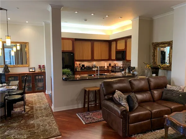 a living room with furniture and kitchen view