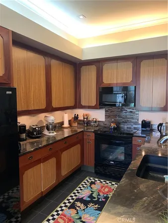 a kitchen with stainless steel appliances granite countertop a stove sink and cabinets