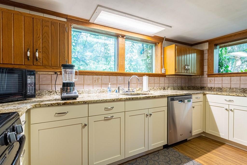 9 Foster Road Milford, NH 03055 - Photo 13 of 31 a kitchen with granite countertop cabinets stainless steel appliances a sink and a large window