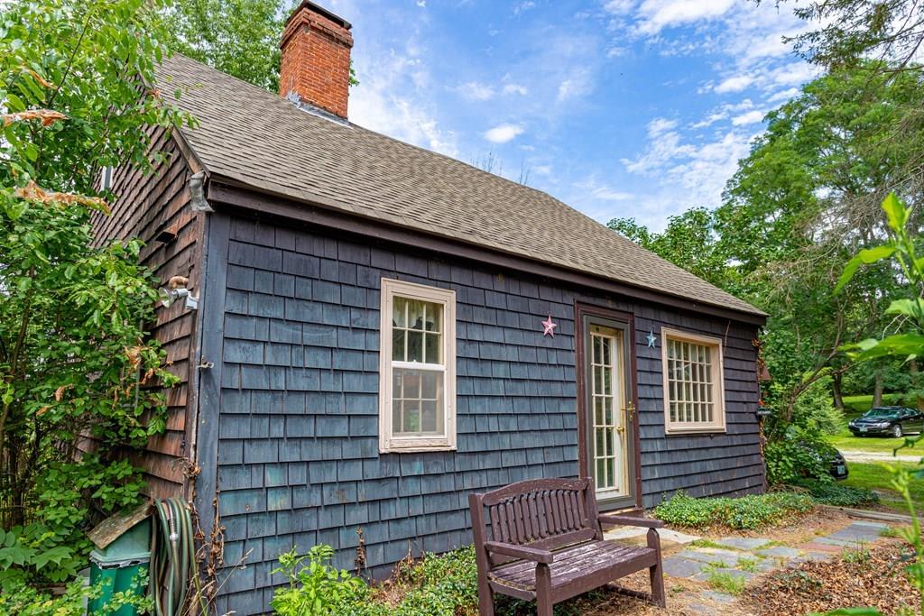 9 Foster Road Milford, NH 03055 - Photo 2 of 31 a brick house with a large window and yard