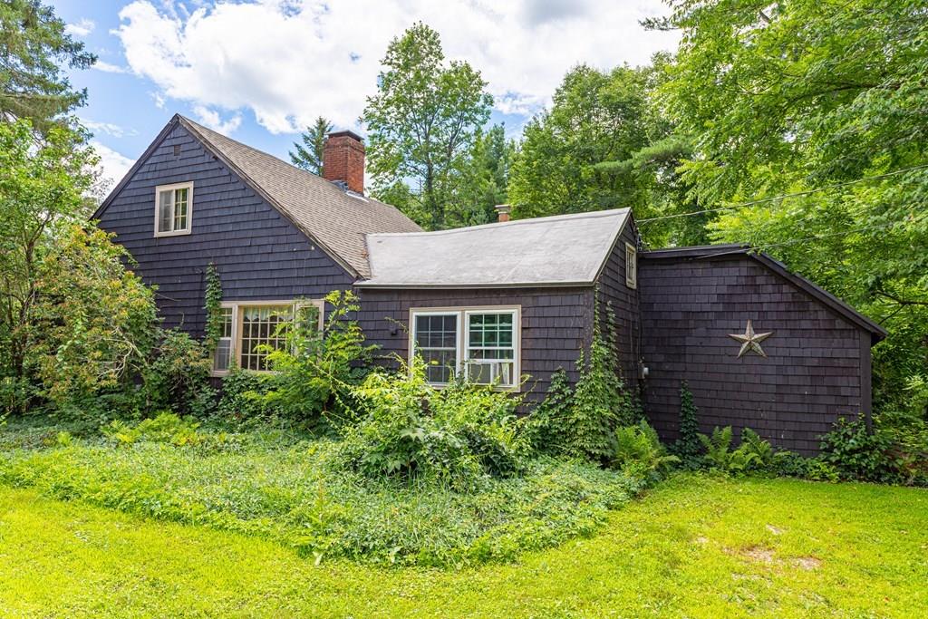 9 Foster Road Milford, NH 03055 - Photo 3 of 31 a view of a house with a yard plants and large tree