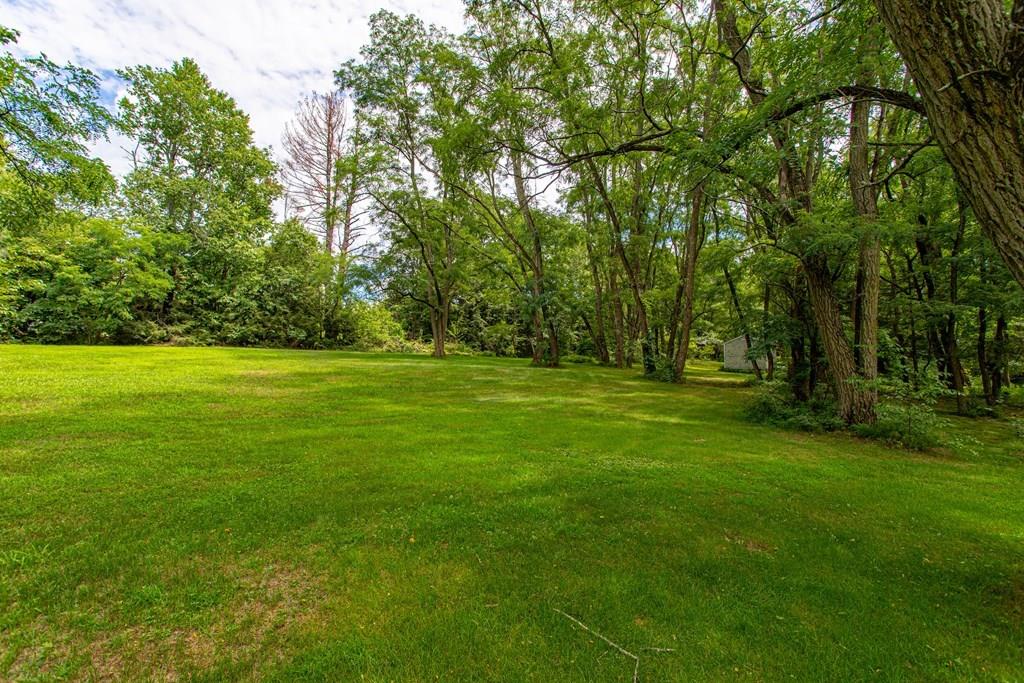 9 Foster Road Milford, NH 03055 - Photo 7 of 31 a view of a grassy field with trees