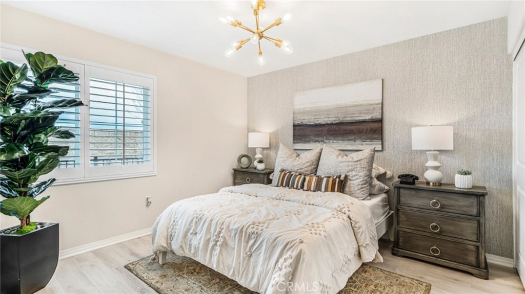 19128 Chestnut Grv Court Riverside, CA 92507 - Photo 7 of 20 a bedroom with a bed and a potted plant