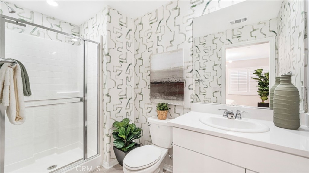 19128 Chestnut Grv Court Riverside, CA 92507 - Photo 8 of 20 a bathroom with a sink a toilet and shower