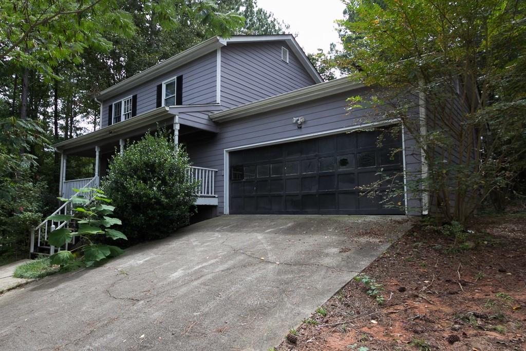727 Deering Road Southeast Conyers, GA 30094 - Photo 1 of 1 a front view of a house with a garden