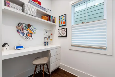 a bedroom with a bed and a table with potted plant