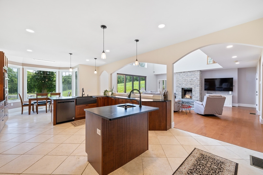 19 Hardscrabble Road Sterling, MA 01564 - Photo 14 of 42 a large kitchen with kitchen island a large counter top cabinets and stainless steel appliances