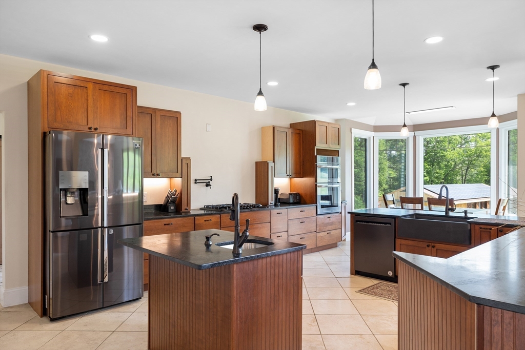 19 Hardscrabble Road Sterling, MA 01564 - Photo 16 of 42 a kitchen with stainless steel appliances granite countertop a sink refrigerator and window