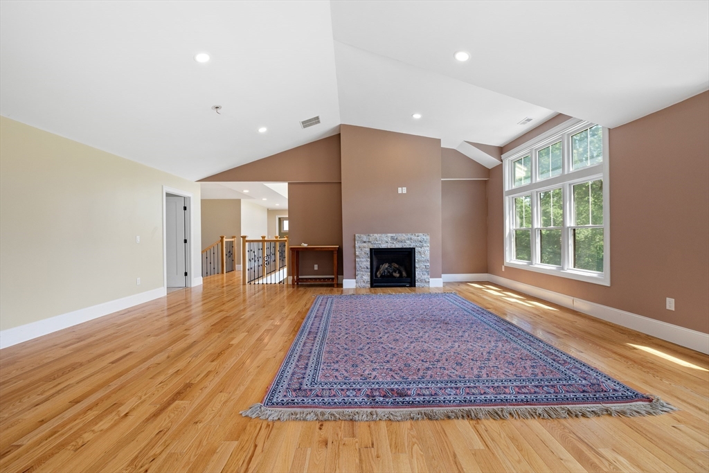 19 Hardscrabble Road Sterling, MA 01564 - Photo 29 of 42 a living room with a fireplace and rug floor