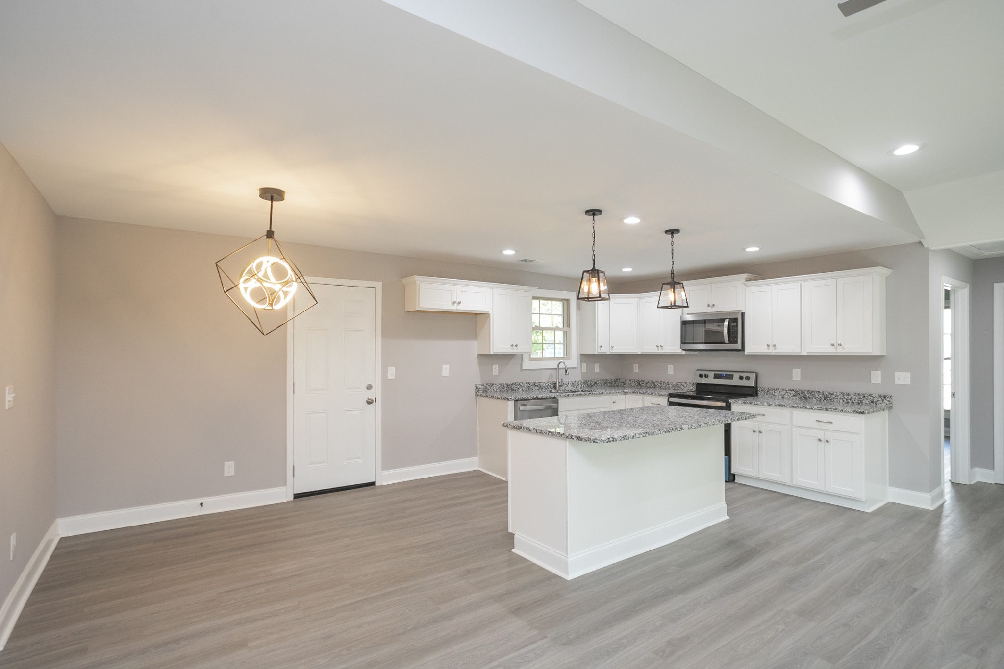 1229 Berwick Trail Madison, TN 37115 - Photo 16 of 47 a kitchen with stainless steel appliances granite countertop a sink a stove a refrigerator and white cabinets with wooden floor
