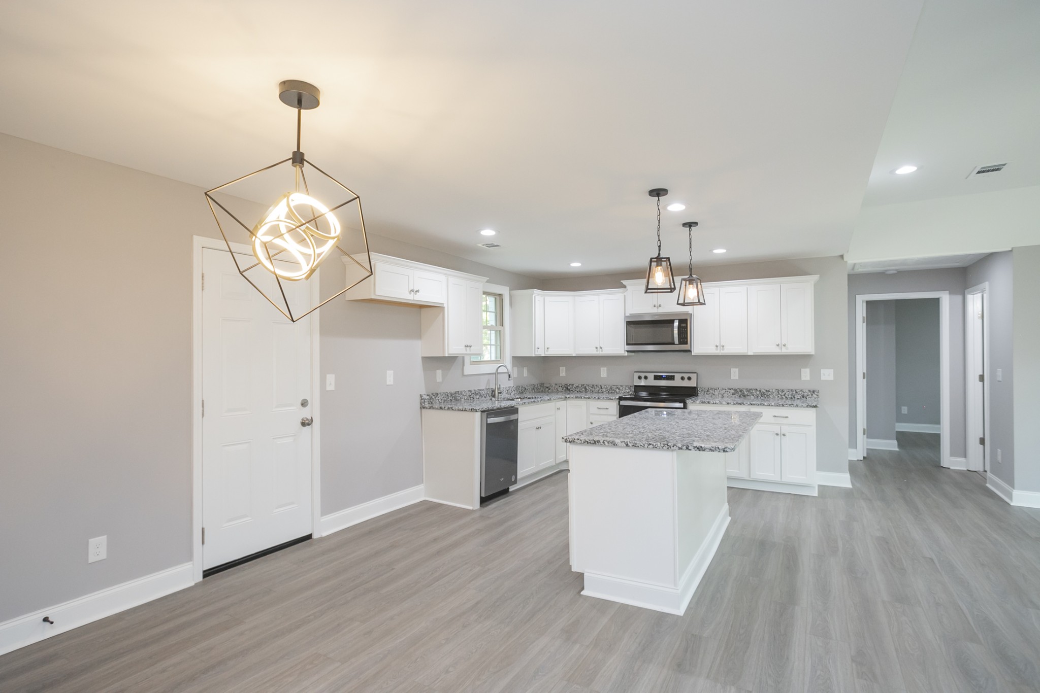 1229 Berwick Trail Madison, TN 37115 - Photo 17 of 47 a kitchen with kitchen island stainless steel appliances a stove top oven a sink a center island and cabinets