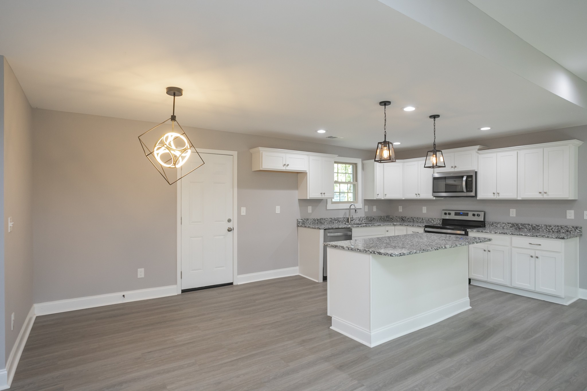1229 Berwick Trail Madison, TN 37115 - Photo 18 of 47 a open kitchen with a stove kitchen island and wooden floor