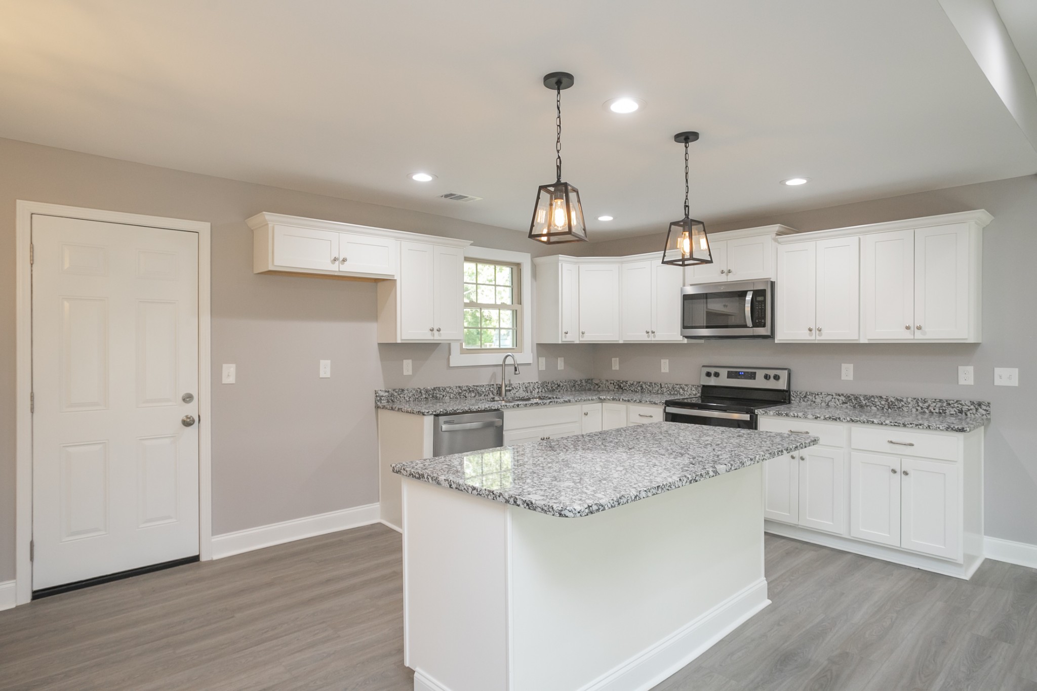 1229 Berwick Trail Madison, TN 37115 - Photo 19 of 47 a kitchen with stainless steel appliances granite countertop a sink a stove a refrigerator cabinets and wooden floor