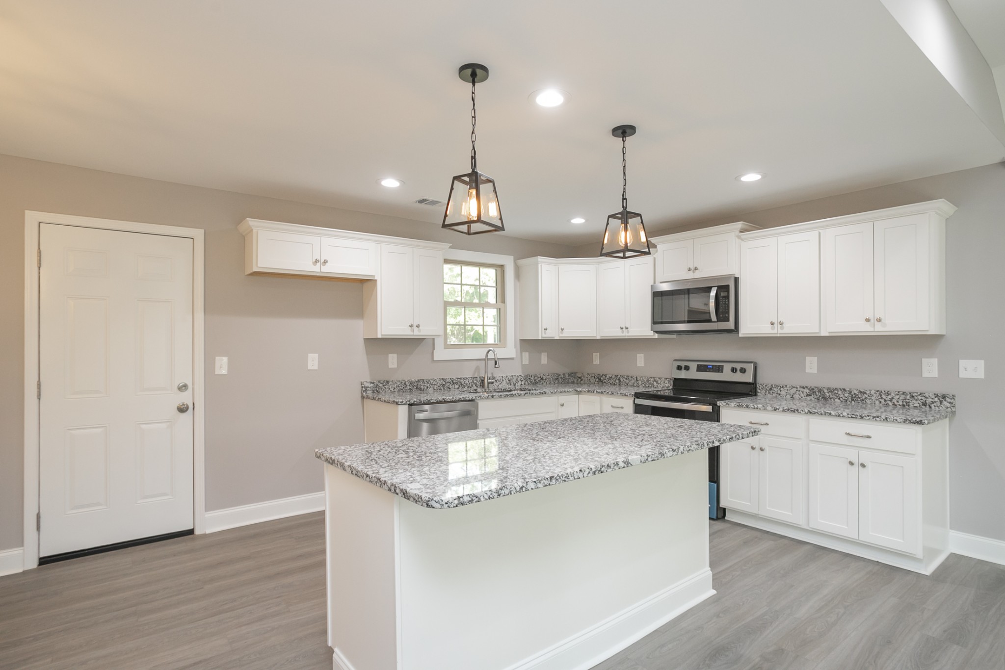 1229 Berwick Trail Madison, TN 37115 - Photo 20 of 47 a kitchen with stainless steel appliances granite countertop a sink a stove a refrigerator and white cabinets