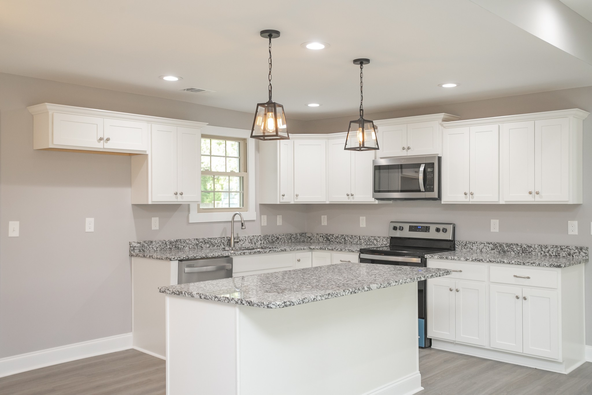 1229 Berwick Trail Madison, TN 37115 - Photo 21 of 47 a kitchen with stainless steel appliances granite countertop a sink a stove a microwave a center island and cabinets