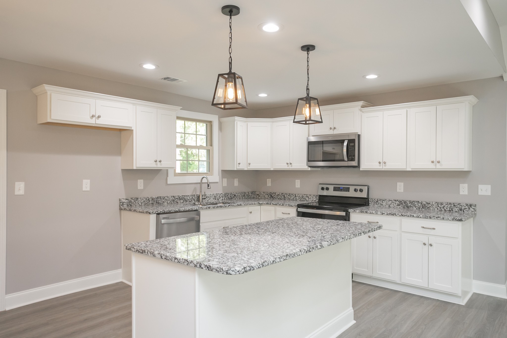 1229 Berwick Trail Madison, TN 37115 - Photo 22 of 47 a kitchen with stainless steel appliances granite countertop a sink a stove a oven a center island and cabinets