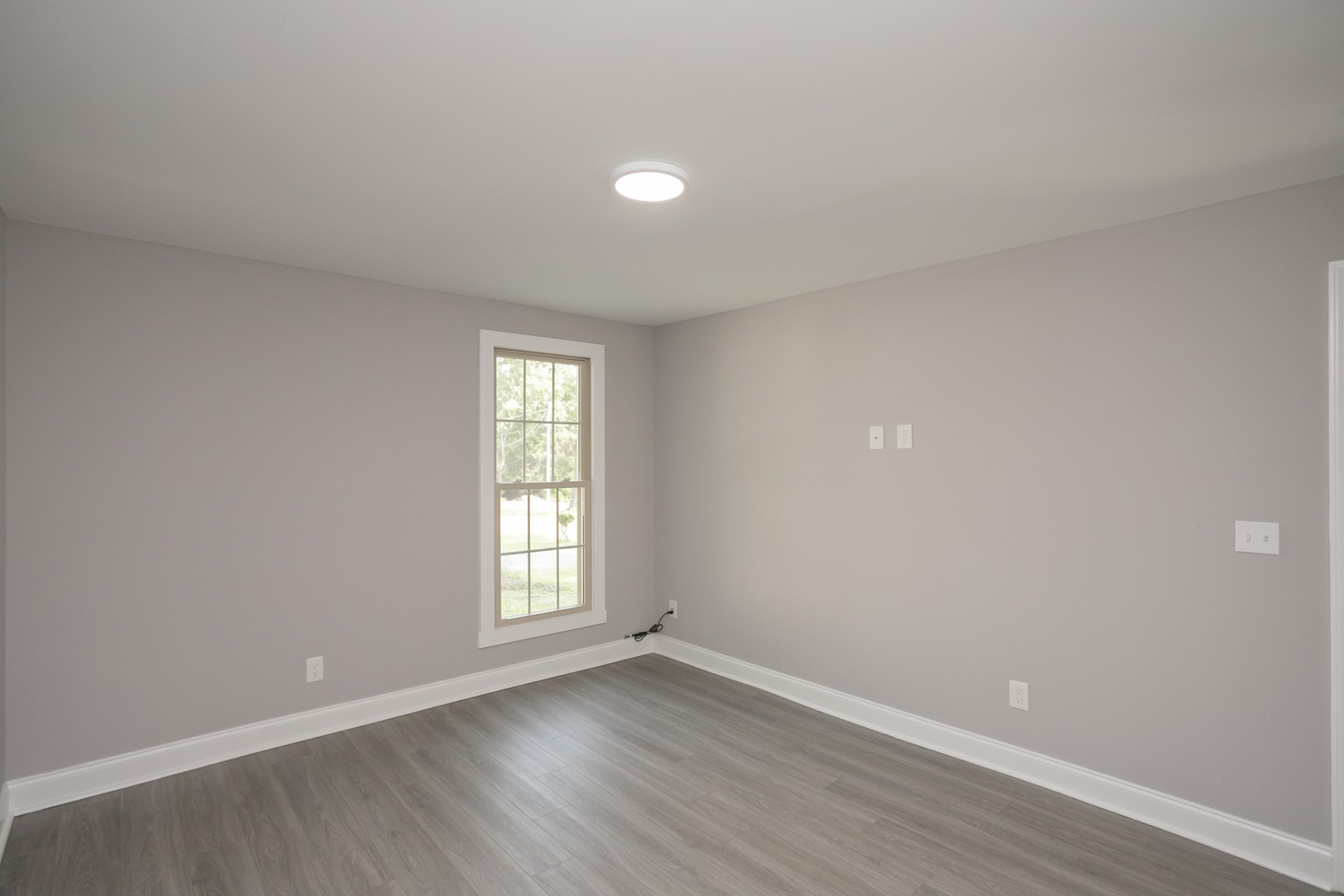 1229 Berwick Trail Madison, TN 37115 - Photo 34 of 47 a view of an empty room with wooden floor and window