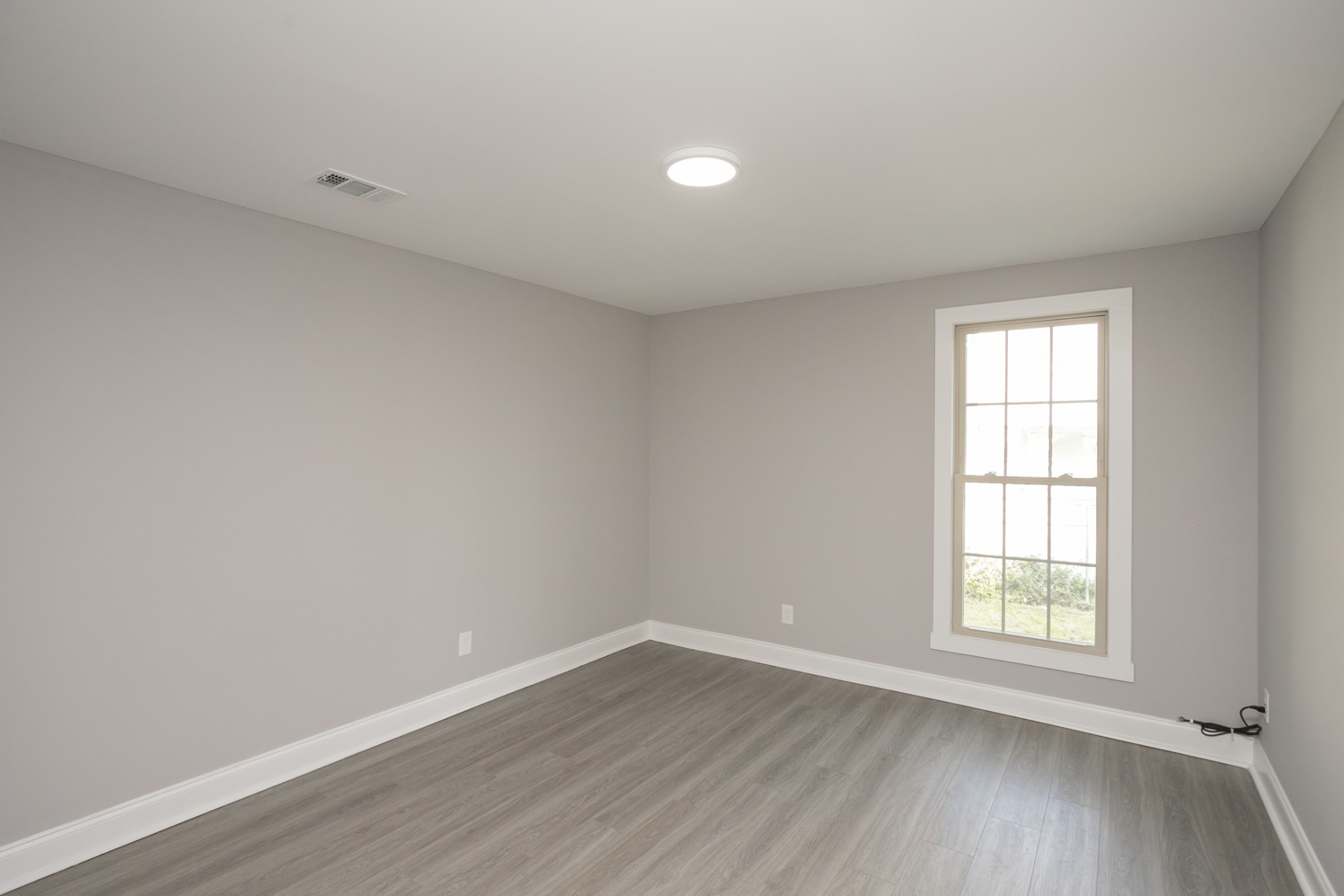 1229 Berwick Trail Madison, TN 37115 - Photo 38 of 47 a view of an empty room with wooden floor and a window