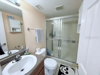 a bathroom with a sink toilet and shower