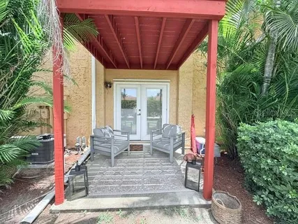 a view of a patio with table and chairs potted plants with wooden floor and plants