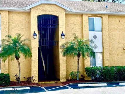 a view of a house with a palm tree