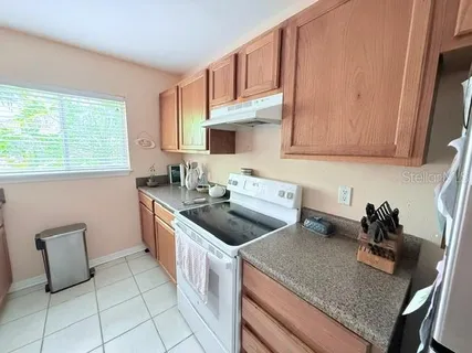 a kitchen with a sink cabinets and window