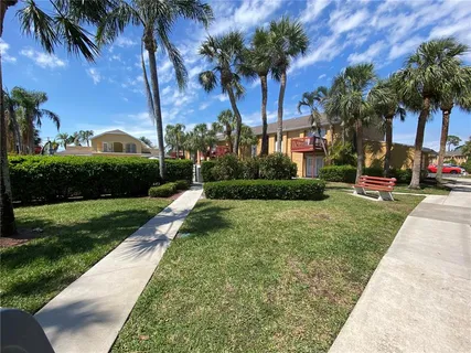 a view of a park with a bench and trees