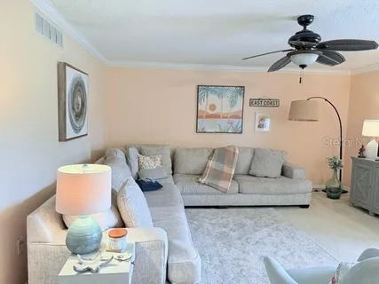 a living room with furniture and white walls