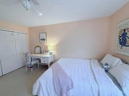 a bedroom with a bed and a table in it