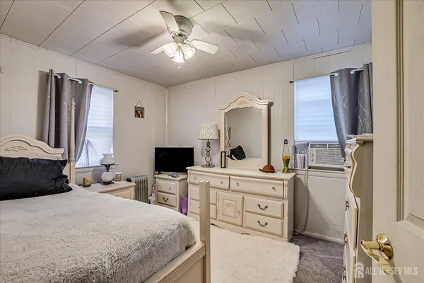 a bedroom with a bed and a desk