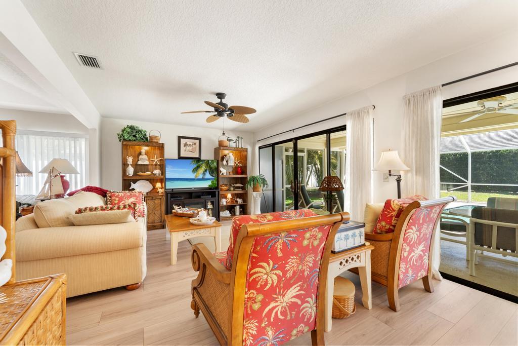 108 Pegasus Drive Jupiter, FL 33477 - Photo 14 of 74 a living room with patio furniture and a large window