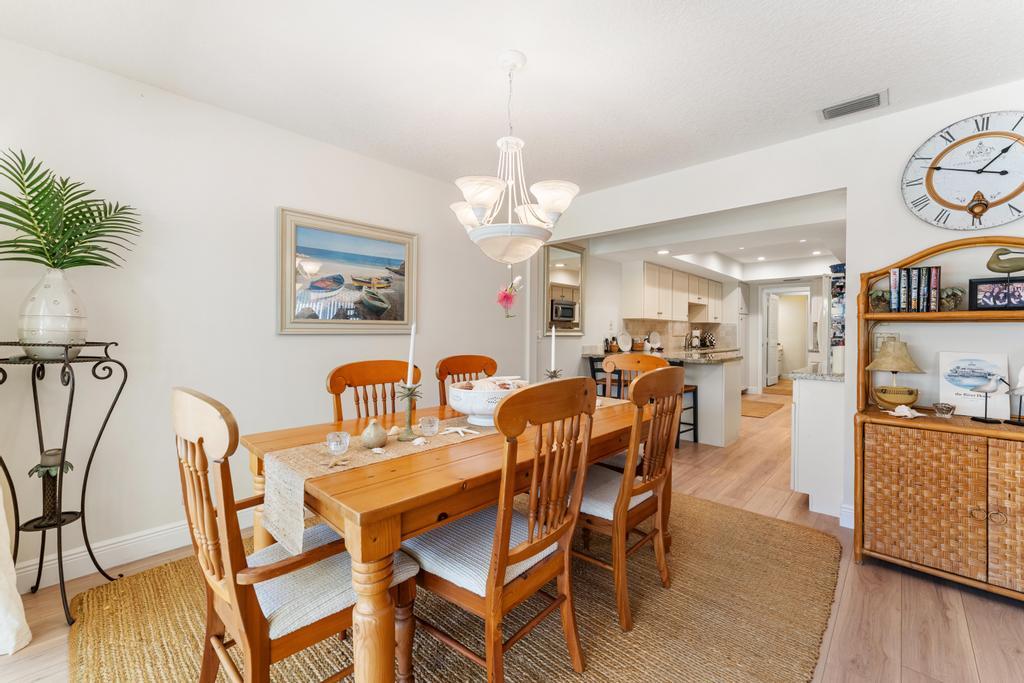 108 Pegasus Drive Jupiter, FL 33477 - Photo 15 of 74 a dining room with furniture and wooden floor