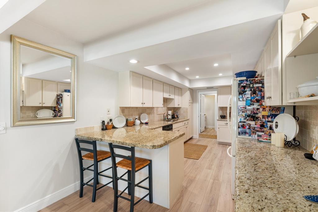 108 Pegasus Drive Jupiter, FL 33477 - Photo 17 of 74 a kitchen with a dining table chairs and a refrigerator