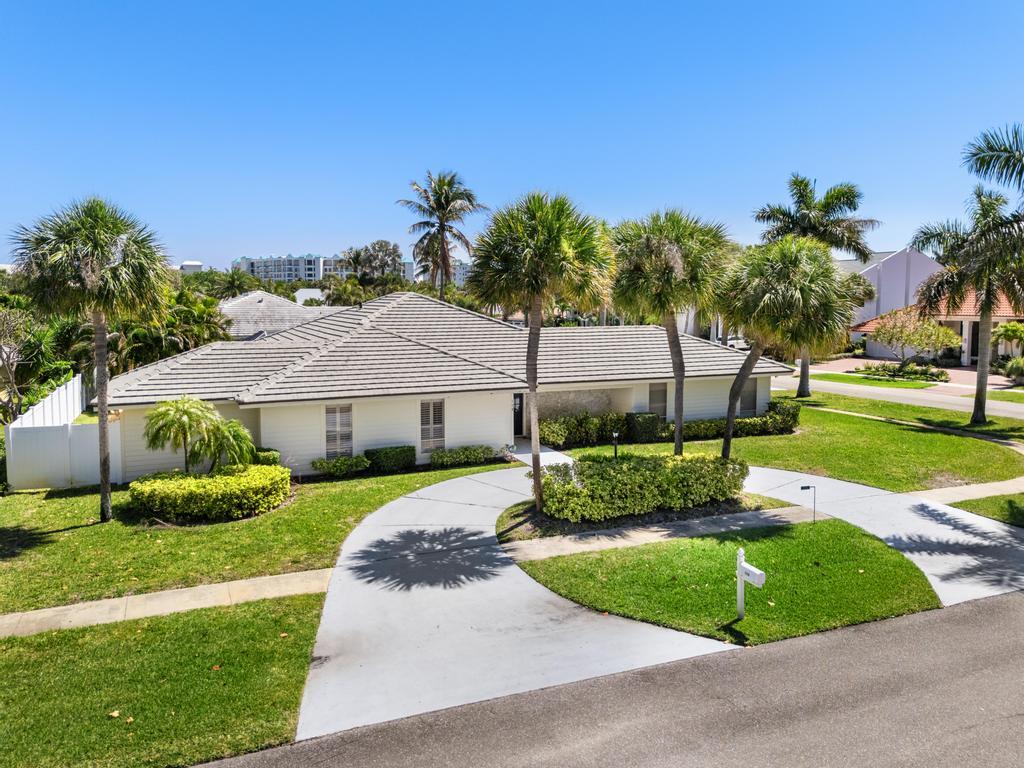 108 Pegasus Drive Jupiter, FL 33477 - Photo 2 of 74 a front view of a house with a yard and garage