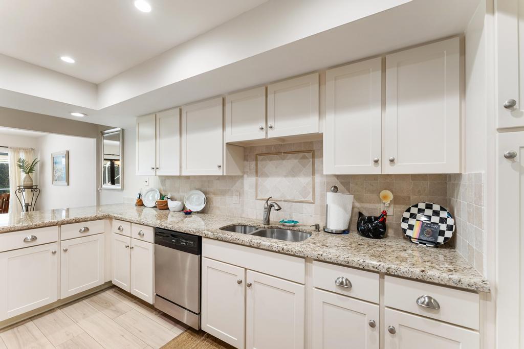 108 Pegasus Drive Jupiter, FL 33477 - Photo 22 of 74 a kitchen with granite countertop white cabinets white appliances and a sink