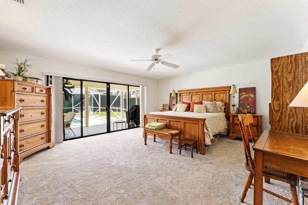 108 Pegasus Drive Jupiter, FL 33477 - Photo 23 of 74 a bedroom with furniture and a large window