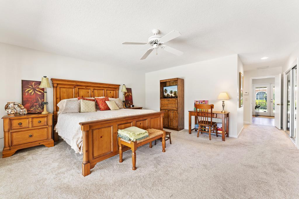 108 Pegasus Drive Jupiter, FL 33477 - Photo 24 of 74 a bedroom with furniture and a chandelier