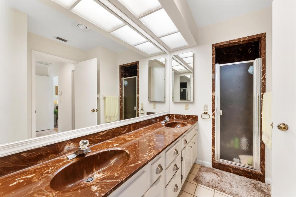 108 Pegasus Drive Jupiter, FL 33477 - Photo 29 of 74 a spacious bathroom with a sink and a mirror